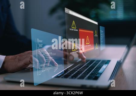 Hands typing on laptop with digital system warning alert on virtual screen, concept of cybersecurity threat, data breach, malware, coding error, onlin Stock Photo
