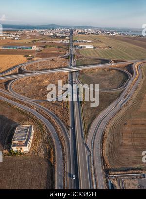 Aerial view of beautiful highway road junction in clover shape at summer day. Logistic concept Stock Photo
