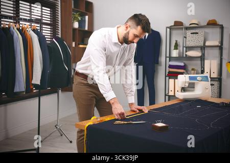 Fashion designer working in studio. Creating stylish clothes Stock Photo