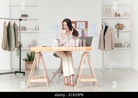 Fashion designer working in studio. Creating stylish clothes Stock Photo
