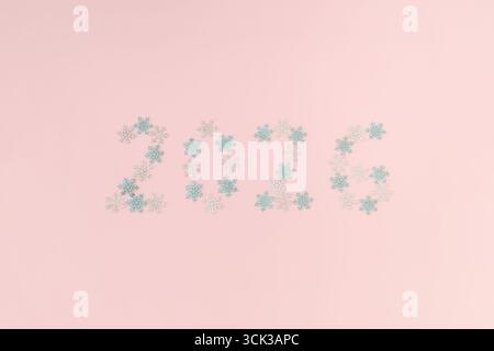 2026 Merry Christmas and happy New Year background. Trendy pastel colors with snowflake decorations. Minimal creative Xmas and New Year flat lay. Star Stock Photo