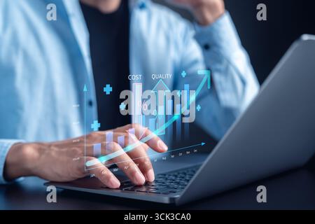 Businessman analyzing cost and quality management graph on laptop business growth, performance Stock Photo