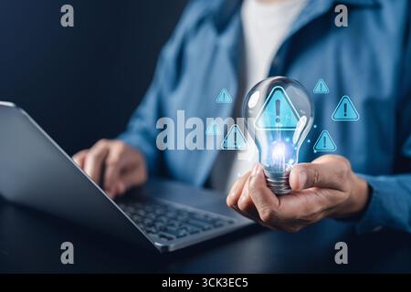 Cybersecurity alert, data warning, risk management, and innovation safety with person holding light Stock Photo