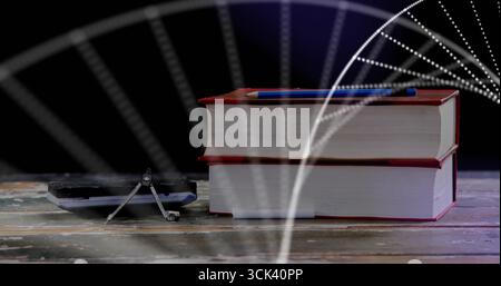 Displaying two red-bound books stacked on studio tabletop with blue pen, compass and calculator Stock Photo