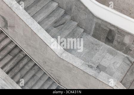 Geometric perspective of a marble staircase showcasing minimalist architecture, emphasizing clean lines and textures, ideal for design, art, or abstra Stock Photo