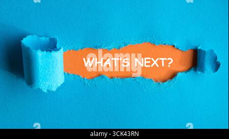 What is next, question on ole ripped in blue paper on orange background. Stock Photo