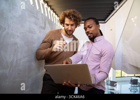 Mixed team of software engineers brainstorming ideas. Diverse app developers collaborating as group Stock Photo
