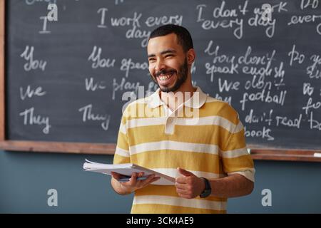 Adult Middle Eastern Man Smiling While Teaching Language Lesson Stock Photo