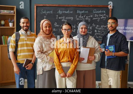 Diverse Young Adult Students Standing Together in Language School Classroom Stock Photo