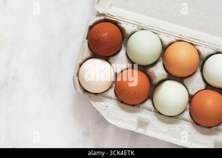 Overhead view of colorful eggs in carton Stock Photo