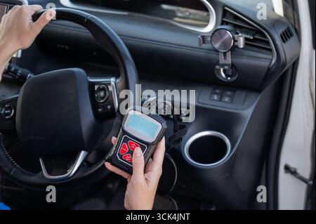 Woman using OBD2 diagnostic scanner.  Stock Photo