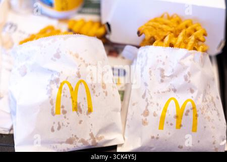 Kerpen, Germany - August, 9, 2025: Waffle fries in branded McDonalds paper bags on tray Stock Photo