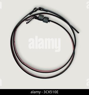 A pair of flexible cables or wires with connectors, likely for electronic or mechanical use. Stock Photo