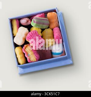 An unique concept of isolated box with candy on plain background , very suitable to use in mostly xmas project. Stock Photo