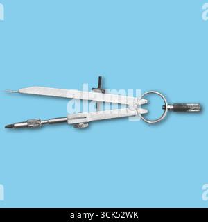 A metallic compass used for drawing circles and measuring distances in geometry and engineering. Stock Photo