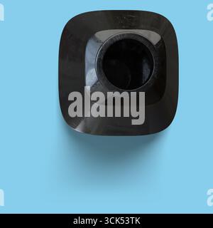 A top view of a sleek, black container designed for pouring liquids. Stock Photo