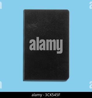 A plain black notebook, ideal for writing notes, sketches, or journaling. Stock Photo