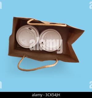 Two beverage cups inside a paper bag, ready for takeout. Stock Photo