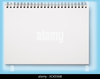 A blank spiral notebook ready for notes or sketches. Stock Photo