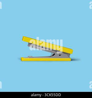 A side view of a yellow and gray stapler, designed for binding sheets of paper together. Stock Photo