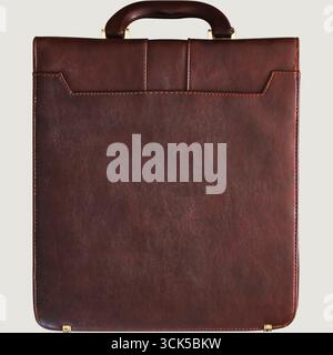 A brown leather briefcase with a handle, designed for carrying documents and professional items. Stock Photo