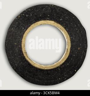 A circular roll of black tape with a central hole, commonly used for various binding or insulating purposes. Stock Photo