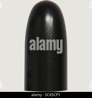A shiny black object resembling a cap or dome, possibly used in cosmetics or design. Stock Photo