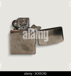 A metallic lighter with an open lid, designed for igniting flames. Stock Photo