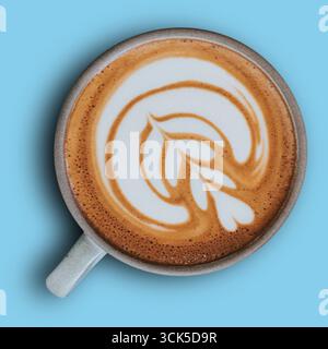 A beautifully crafted cup of coffee with latte art, showcasing intricate swirls and leaf patterns on a creamy surface. Stock Photo