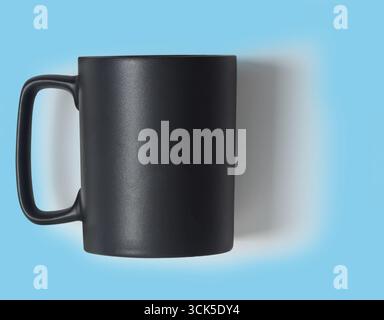 A sleek black mug positioned against a light background, ideal for beverages. Stock Photo