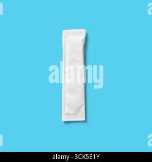 A small, unmarked white packet, likely containing a single-use item or substance. Stock Photo