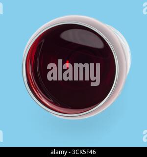 A close-up view of a glass filled with red liquid, likely wine, showcasing its rich color and reflective surface. Stock Photo
