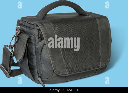 A compact black messenger bag designed for carrying photography equipment or personal items. Stock Photo