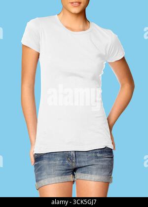 A plain white t-shirt worn by a model with denim shorts, showcasing casual fashion. Stock Photo