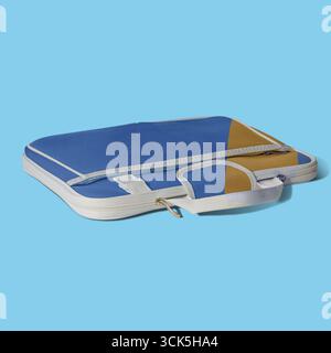 A blue and yellow laptop case with a handle, designed for protection and portability of electronic devices. Stock Photo