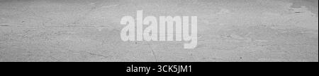 A textured gray surface with subtle patterns, possibly concrete or stone, suitable for backgrounds or design purposes. Stock Photo