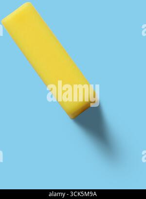 This image shows a yellow rectangular eraser, commonly used for correcting pencil marks on paper. Stock Photo