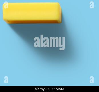 A simple yellow rectangular eraser, commonly used for correcting pencil marks on paper. Stock Photo