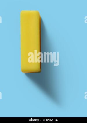 A yellow rectangular eraser, commonly used for correcting pencil marks on paper. Stock Photo