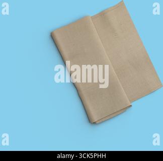 A folded piece of beige fabric, potentially used for various purposes such as decoration, clothing, or crafting. Stock Photo