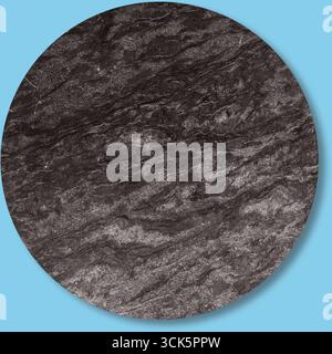 A textured circular surface resembling dark stone or mineral with subtle patterns. Stock Photo