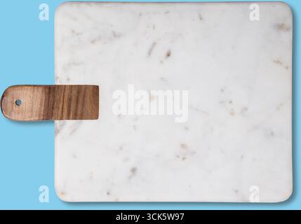 A rectangular marble cutting board with a wooden handle, ideal for food preparation and serving. Stock Photo
