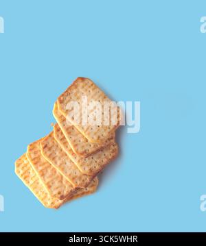 A stack of crispy crackers arranged neatly, showcasing their texture and color. Ideal for snacking or serving with dips. Stock Photo