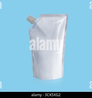 A clear plastic pouch with a spout, commonly used for packaging liquids or semi-liquids. Stock Photo