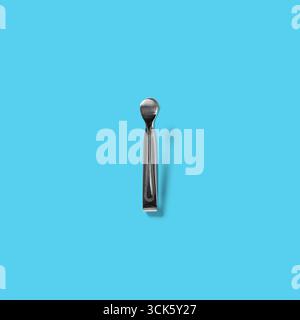 A simple metallic spoon with a sleek design, often used for serving or eating food. Stock Photo