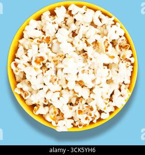 A bowl of fluffy popcorn, perfect for snacking during movies or gatherings. Stock Photo