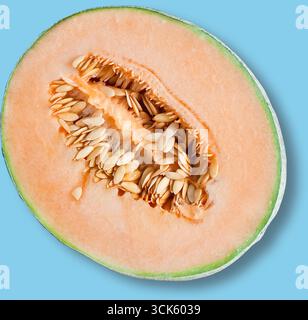 A halved cantaloupe melon showcasing its orange flesh and seeds, highlighting its fresh and nutritious appeal. Stock Photo