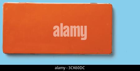 A simple orange rectangular object, possibly a container or box, with a smooth surface and no visible markings. Stock Photo