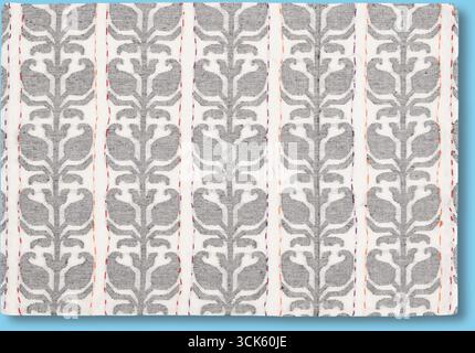 A patterned textile featuring intricate floral designs in gray on a light background. Stock Photo