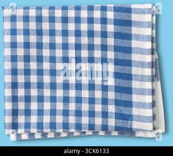 A folded blue and white checkered cloth, commonly used as a table napkin or kitchen towel. Stock Photo